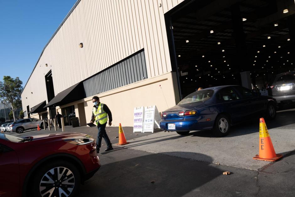 cars driving into vaccination clinic in Event Center pavilion 