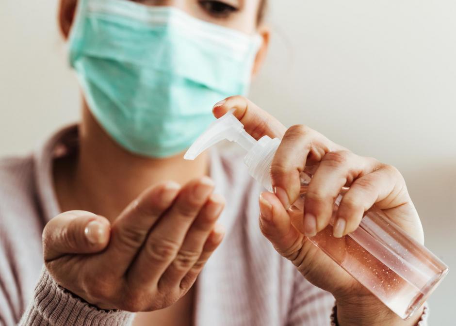 Woman using hand sanitizer