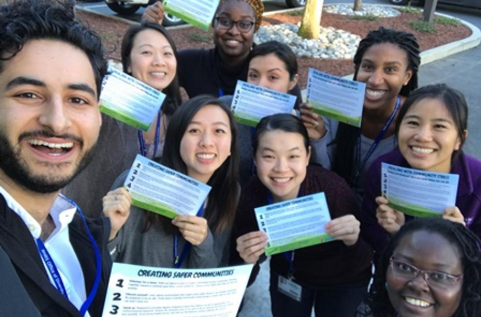 ODE Staff holding "Dealing With Community Stress" cards