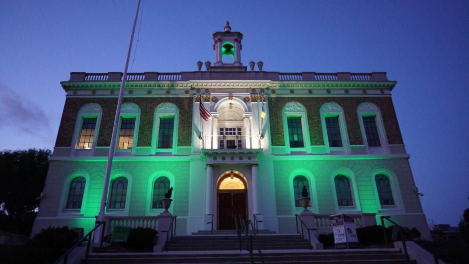 South San Francisco City Hall building lit up in lime green.