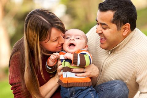 A mother and father with their baby