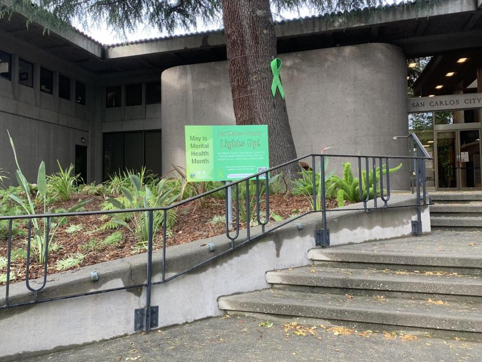 San Carlos City Hall Building with May is Mental Health Month lawn sign.